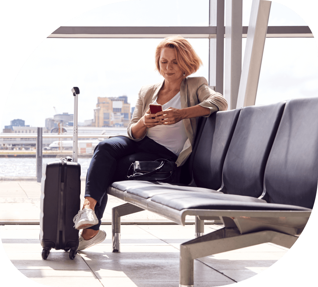 woman relaxing with phone in airport lounge