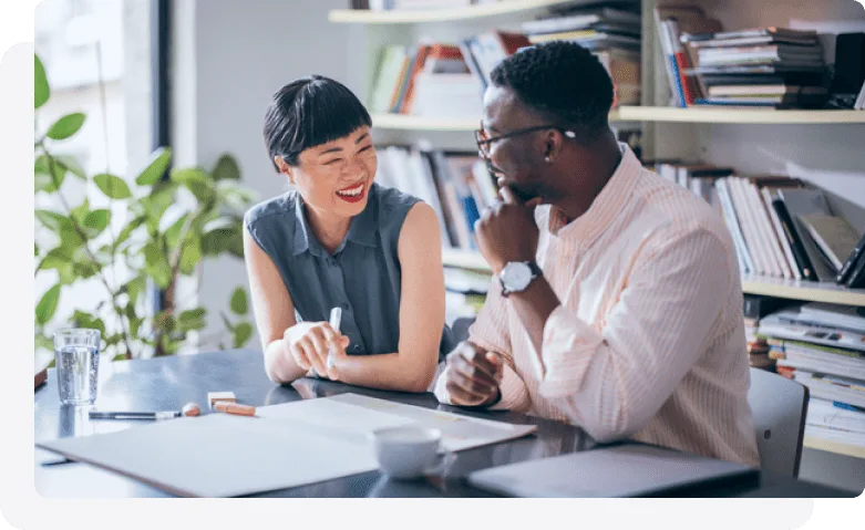 Two individuals at their desk collaborating on a project.