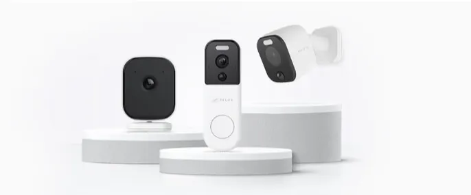 A TELUS Indoor, Doorbell and Outdoor camera are featured on podiums. 