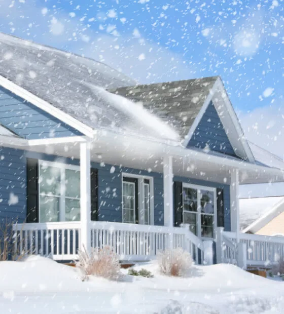 A house in the winter covered in snow. 