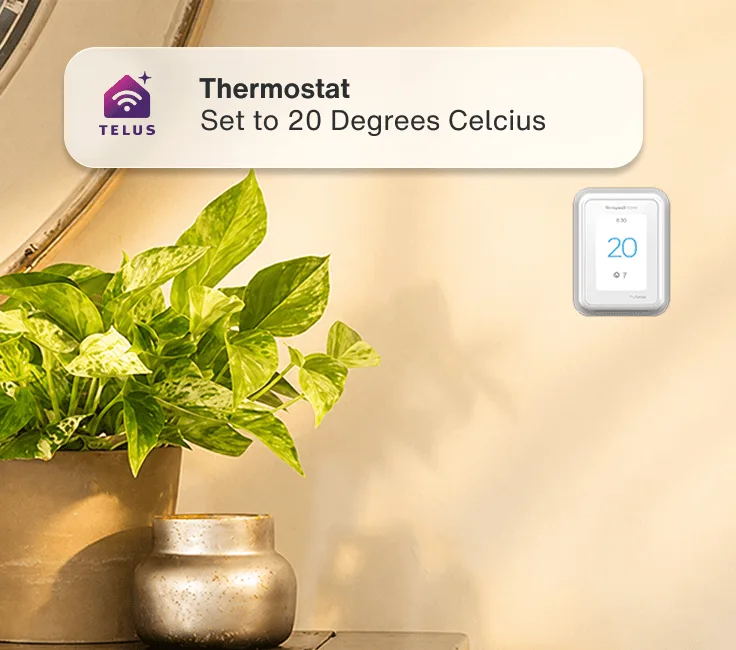 A hand setting a wall smart thermostat with a green fern to the left. An app alert reads: ”Thermostat - Set to 20 Degrees Celcius”