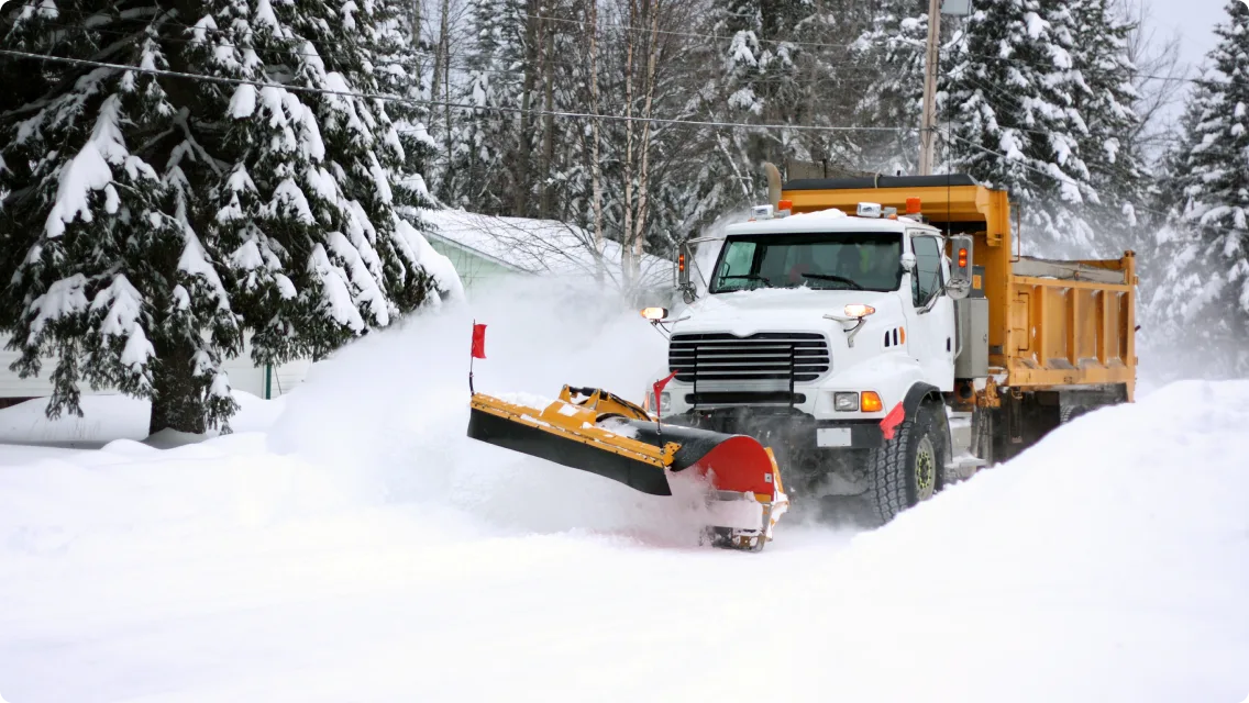 Municipal vehicle clearing snow from public road