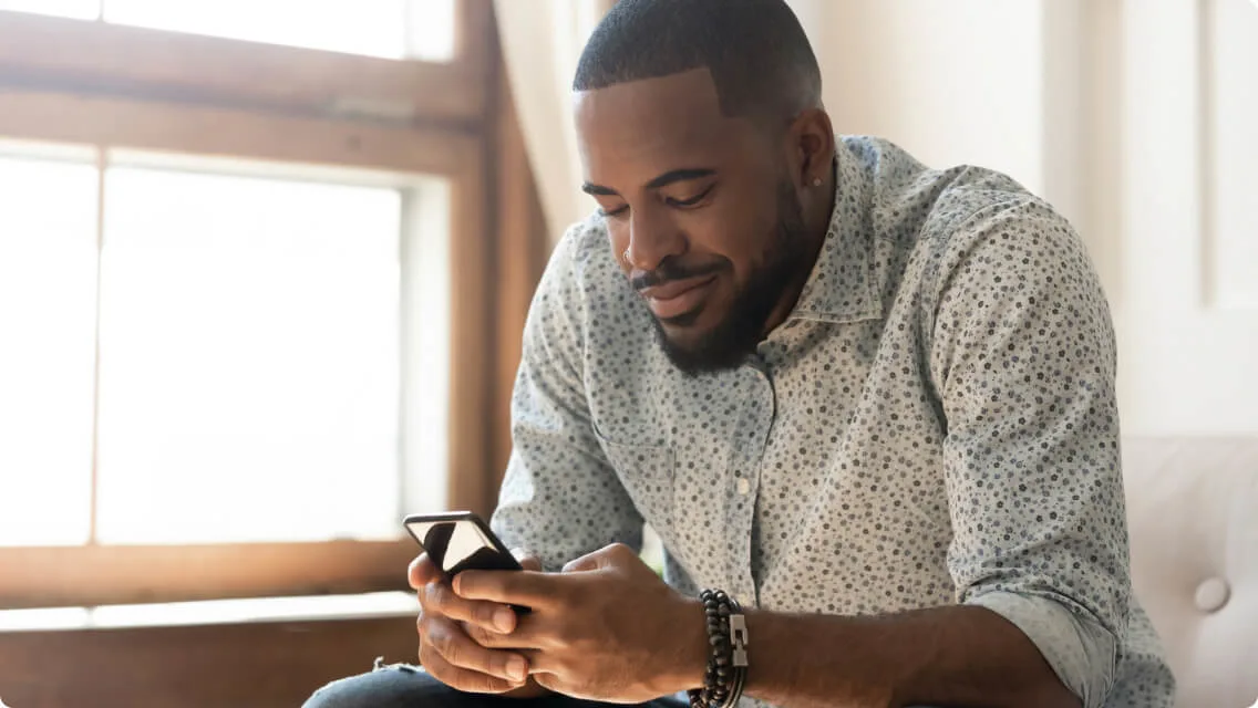Young mom with her toddler, smiling at phone screen
