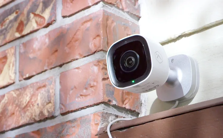 An outdoor security camera outside a home