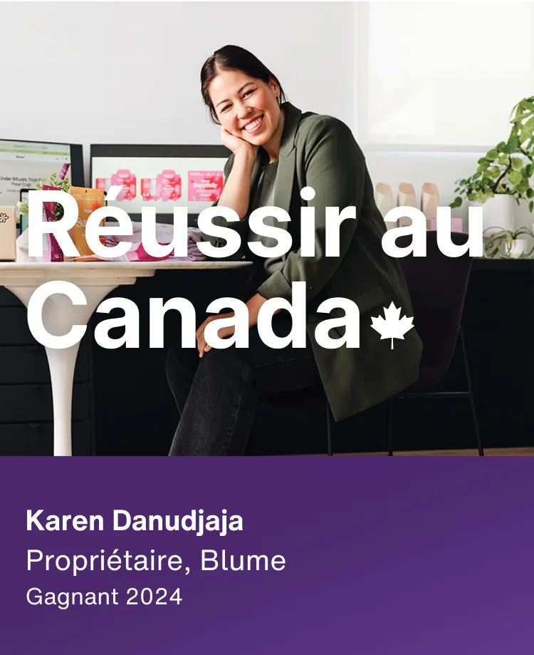 La gagnante de 2024, Karen Danudjaja, propriétaire de Blume, est assise à un bureau avec deux écrans et des plantes. Le texte superposé dit « Made it in Canada » avec une feuille d'érable.