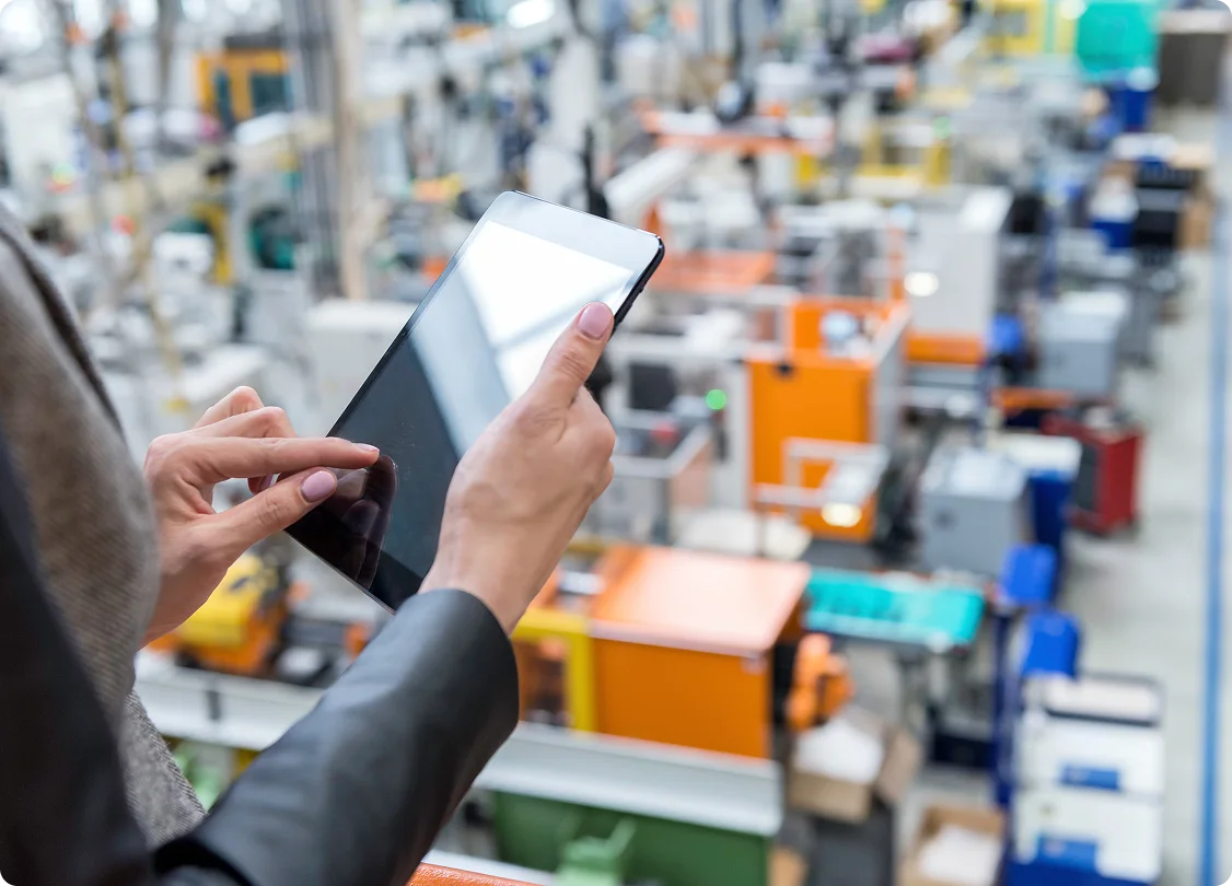 Worker using tablet in manufacturing facility