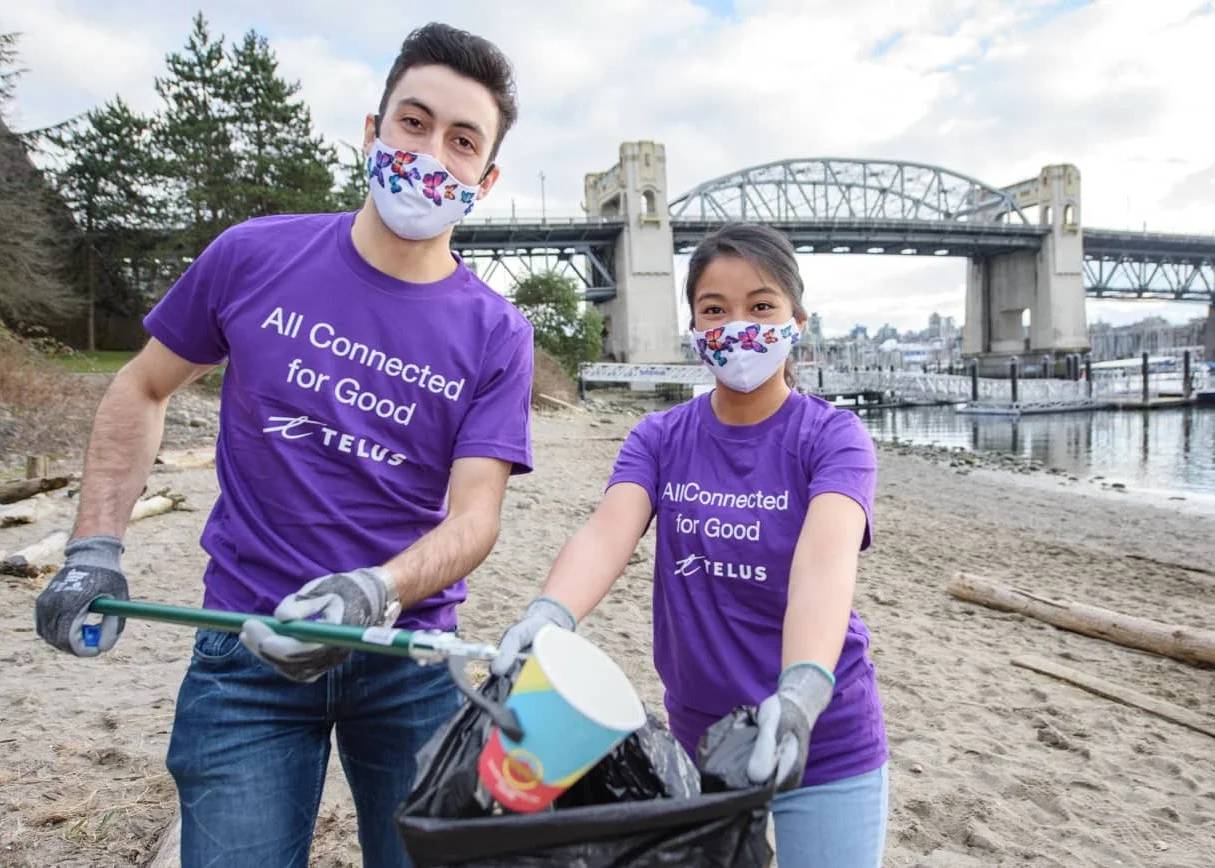 TELUS team members cleaning up a beach