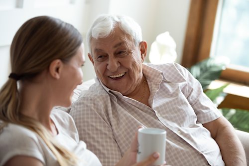 Elderly man talking with grown up daughter