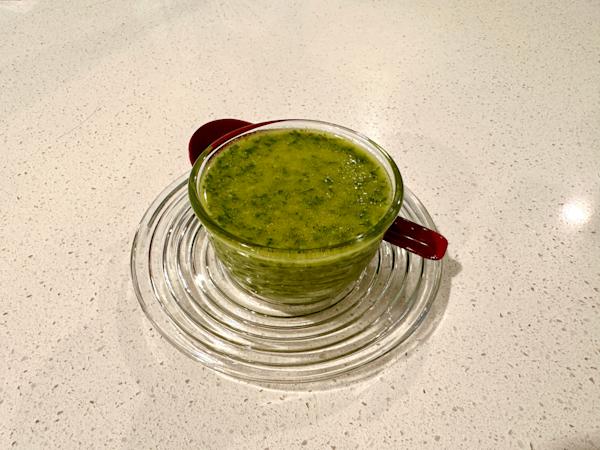 A bowl of blended mint chimichurri sauce.