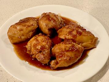 A plate of honey garlic chicken with sauce.