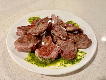 A plate of lamb chops with mint chimichurri.