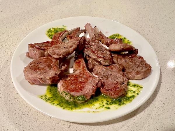 A plate of lamb chops with mint chimichurri.