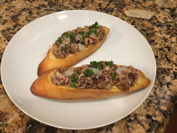 Pilchard and pickle spread on a garlic crostini.