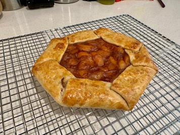 An apricot galette on a cooling rack.