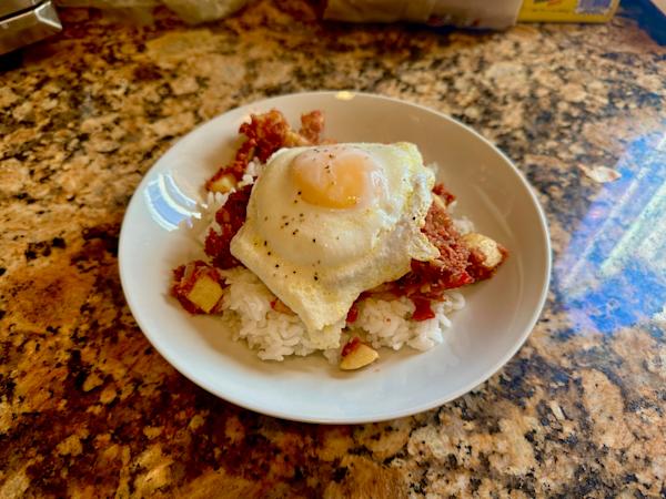 Filipino corned beef hash with a fried egg.