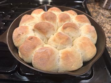A cast iron skillet with yeast rolls.