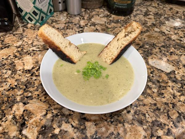 A bowl of celery soup with toasted crostini.
