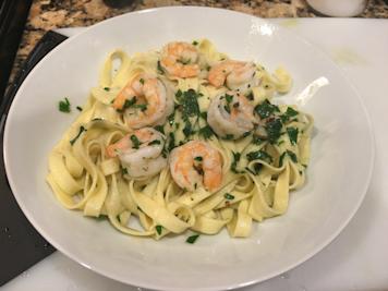 Garlic shrimp tossed with fresh pasta and chopped parsley.