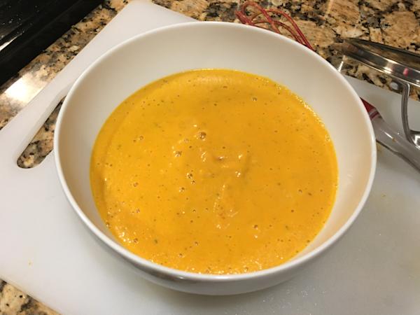 A bowl of pureed carrot soup.