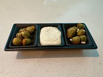 A tray of fried olives with lemon garlic aioli.
