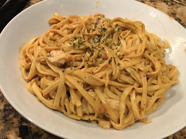 Thai peanut sauce on fresh fettuccine with chicken.