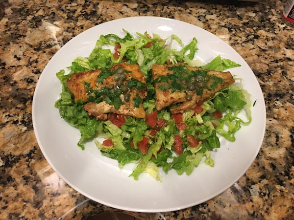 Sole Meunière on a bed of chopped salad.