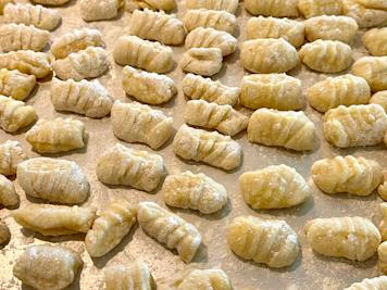 A sheet pan covered with fresh gnocchi.