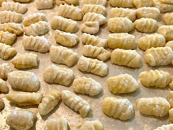 A sheet pan covered with fresh gnocchi.