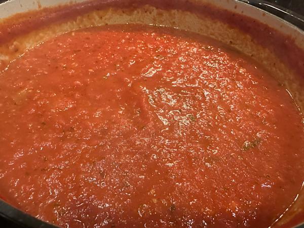 A simmering pot of marinara sauce.