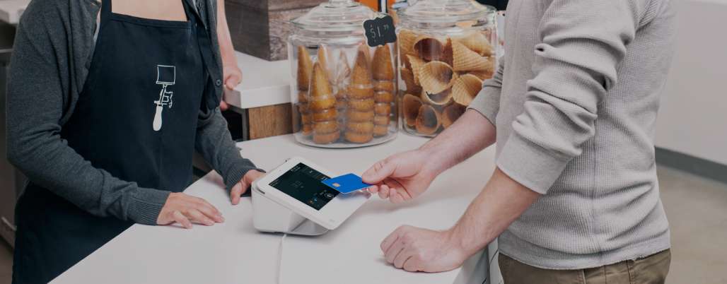 Person paying using Clover point-of-sale platform