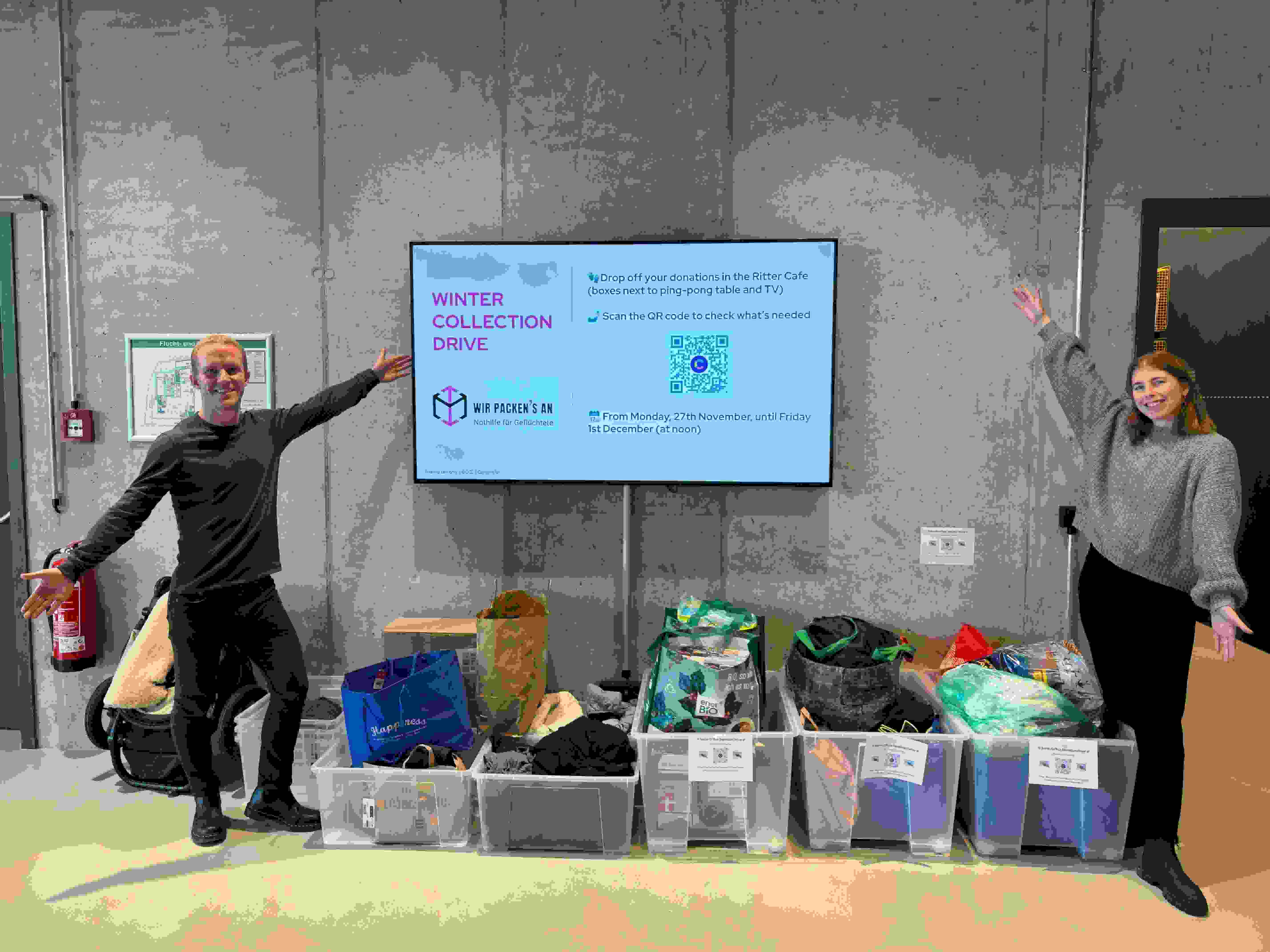 Luisa (right) and Kevin Harris, Lead Recruiting Coordinator, proudly presenting the donations from a winter collection drive.