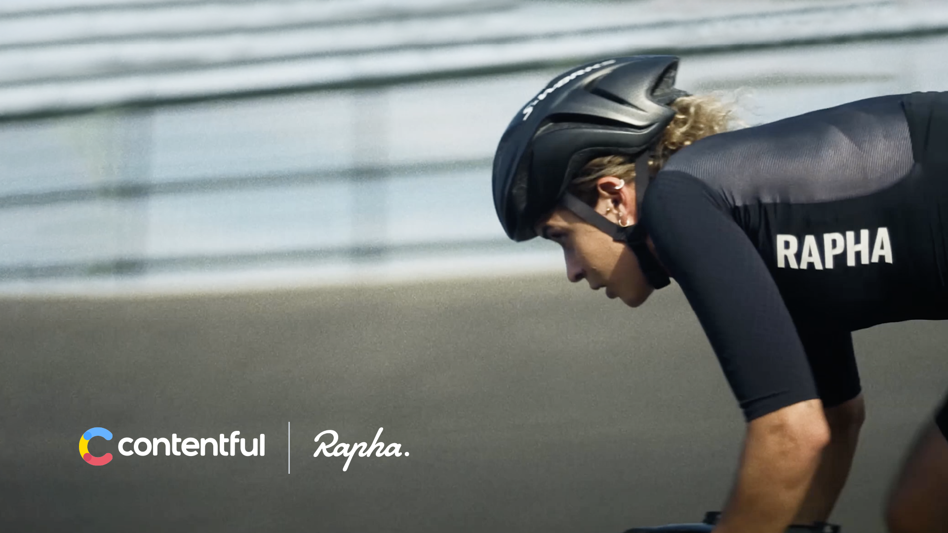 A person rides a bike wearing Rapha-branded clothing
