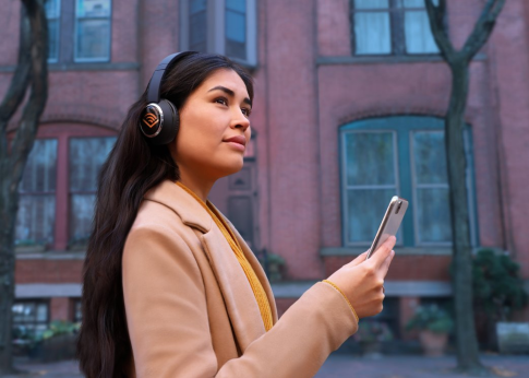 A person listens to a podcast wearing Audible branded headphones.