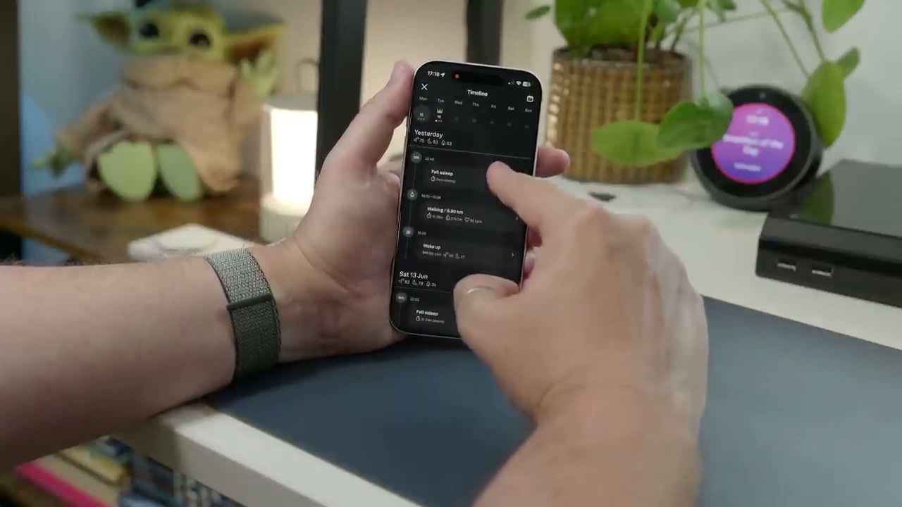 Close-up%20of%20the%20Oura%20Ring%205%20resting%20on%20its%20minimalist%20square%20charging%20stand%2C%20highlighting%20its%20sensor%20design.