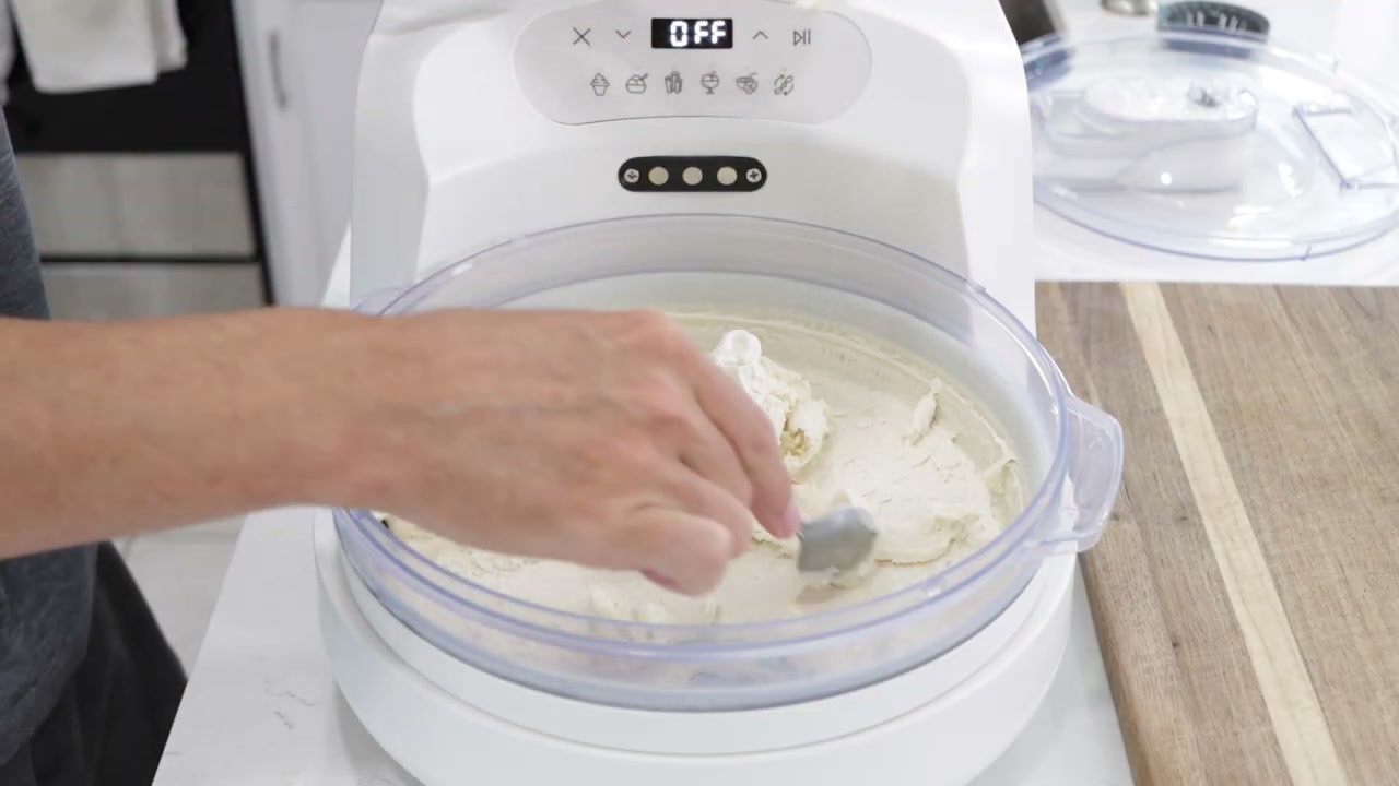 Reviewer%20scoops%20freshly%20made%20vanilla%20ice%20cream%20from%20the%20InstantChill%20machine%2C%20revealing%20its%20soft-serve%20consistency.