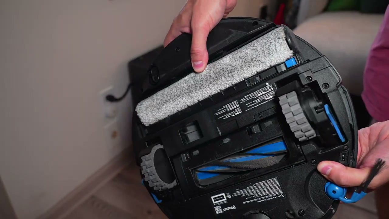 Reviewer%20demonstrating%20the%20ECOVACS%20DEEBOT%20T90%20PRO%20OMNI%20robot%20vacuum%20and%20its%20unique%20Osmo%20Roller%203.0%20mop%20system.