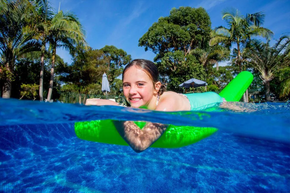 Girl swimming in pool at an NRMA Holiday Park