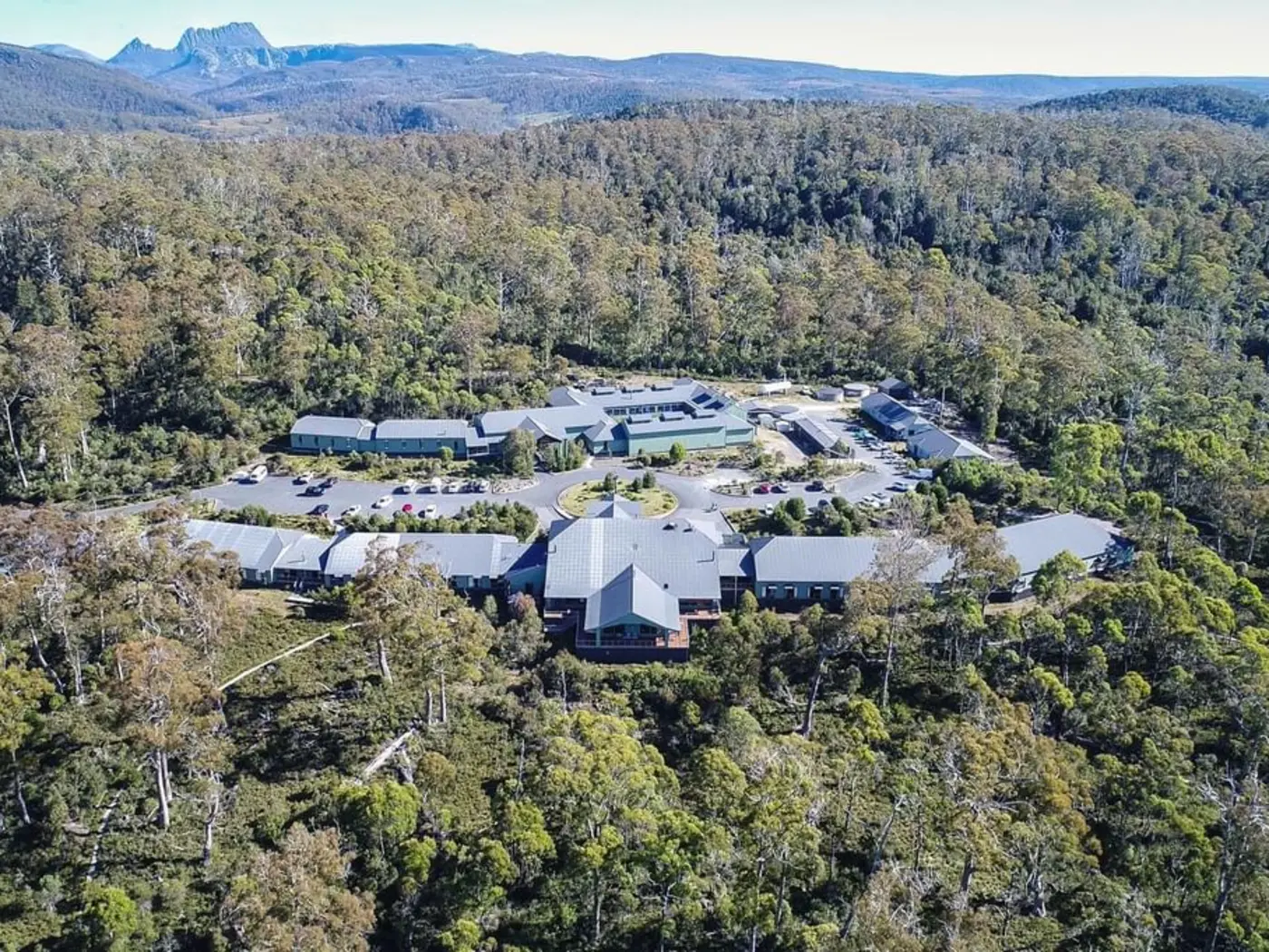 Aerial view of the Cradle Mountain Hotel surrounded by trees