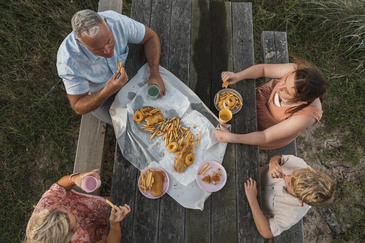 Family eating fish and chips at Woodgate 