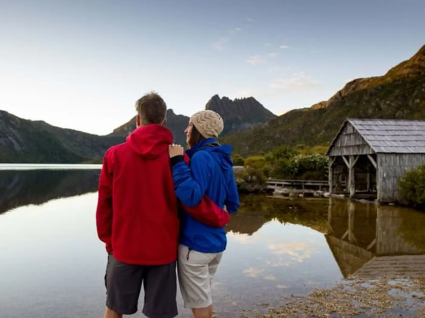 Landscape view of a couple close together enjoying the lake view near Freycinet Lodge