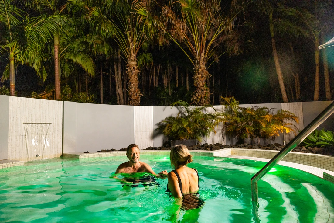 Couple having night time spa in Angourie Resort jacuzzi, Yamba