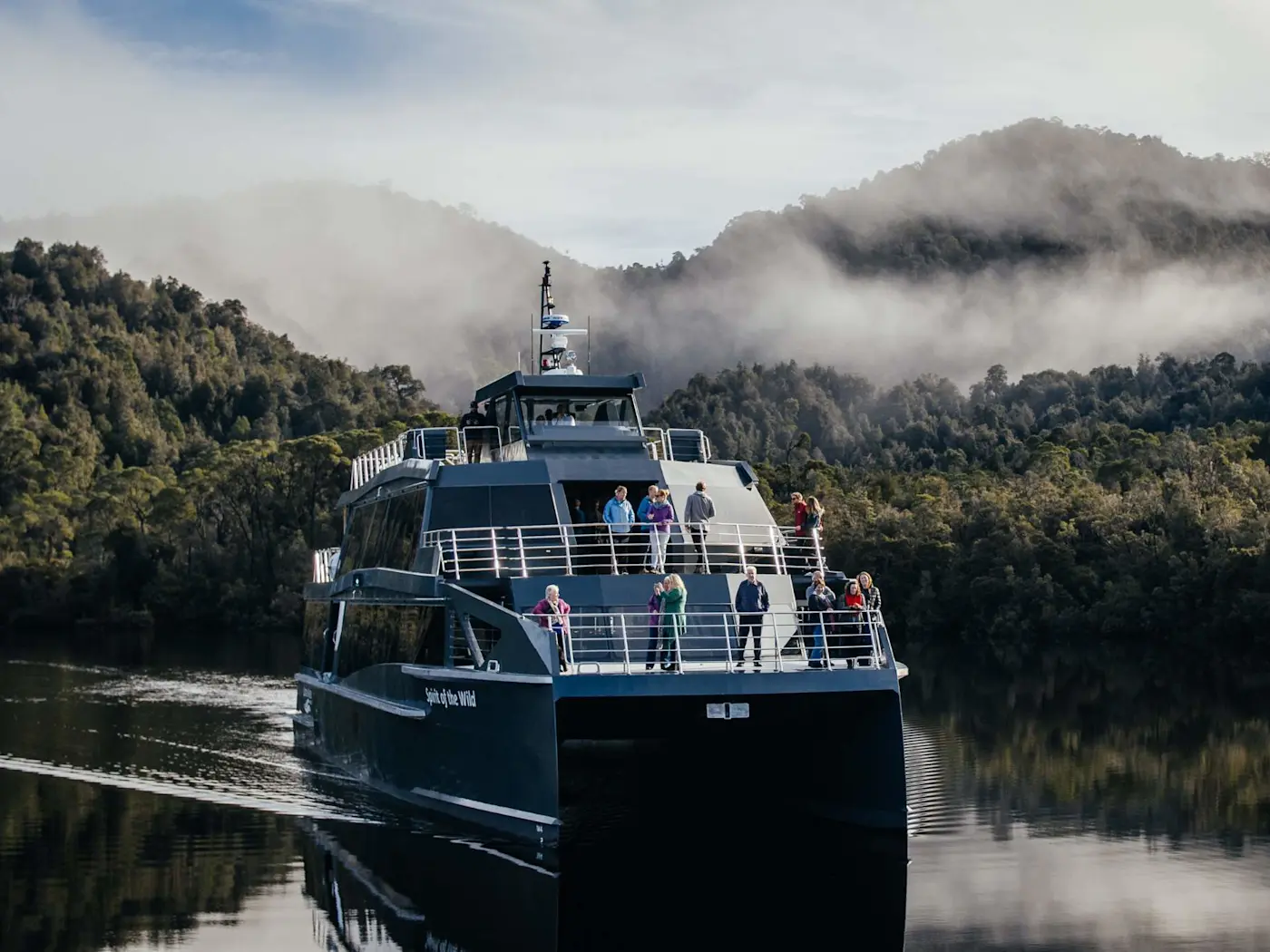 Gordon River Cruises navigating through calm water near Strahan Village