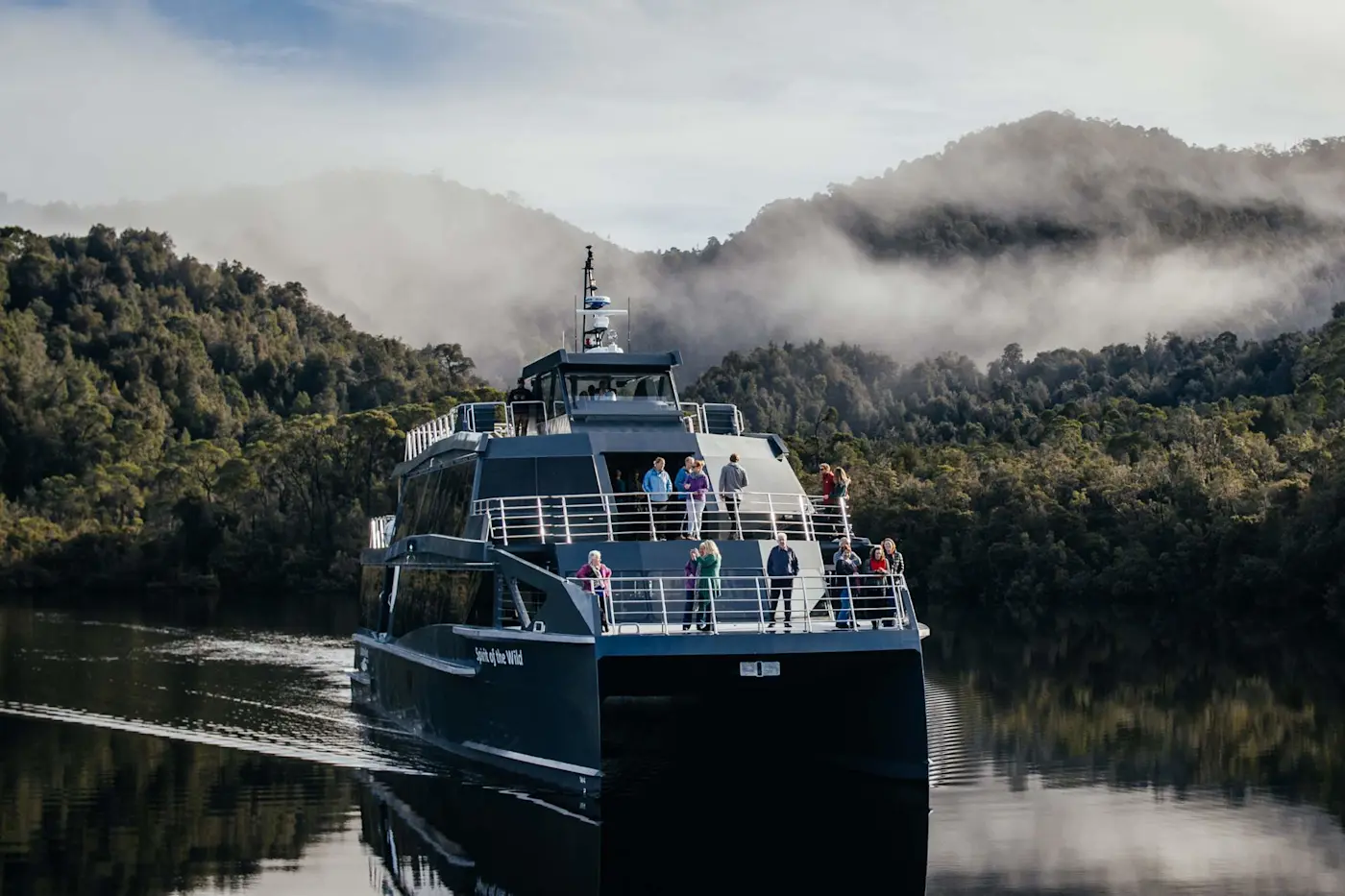 Gordon River Cruises navigating through calm water near Strahan Village