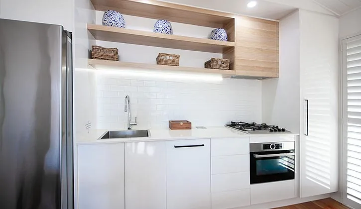 A white kitchen with all the essentials inside an Agnes Water holiday park