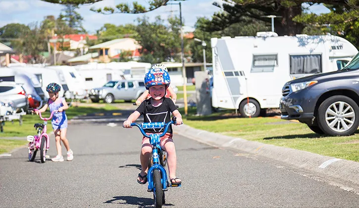 SB 725x420 boy riding bike in a Shellharbour caravan park