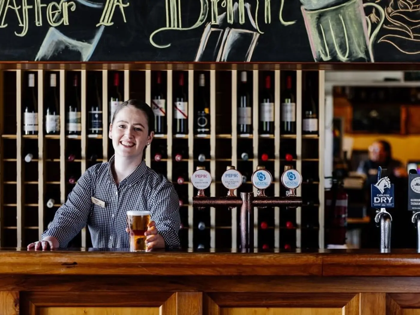 A Bartender in Hamer's Bar & Bistro at Strahan Village