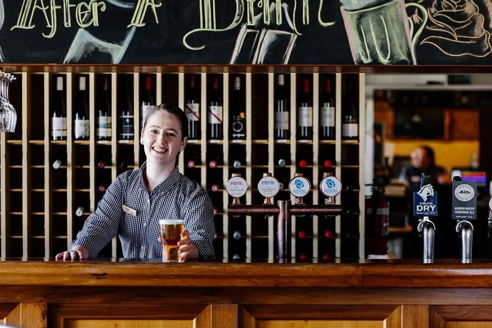 A Bartender in Hamer's Bar & Bistro at Strahan Village