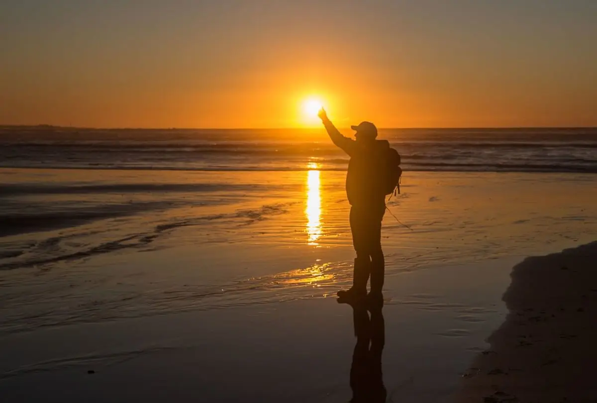Man watching the sunset at the beach near Gordon River Cruise