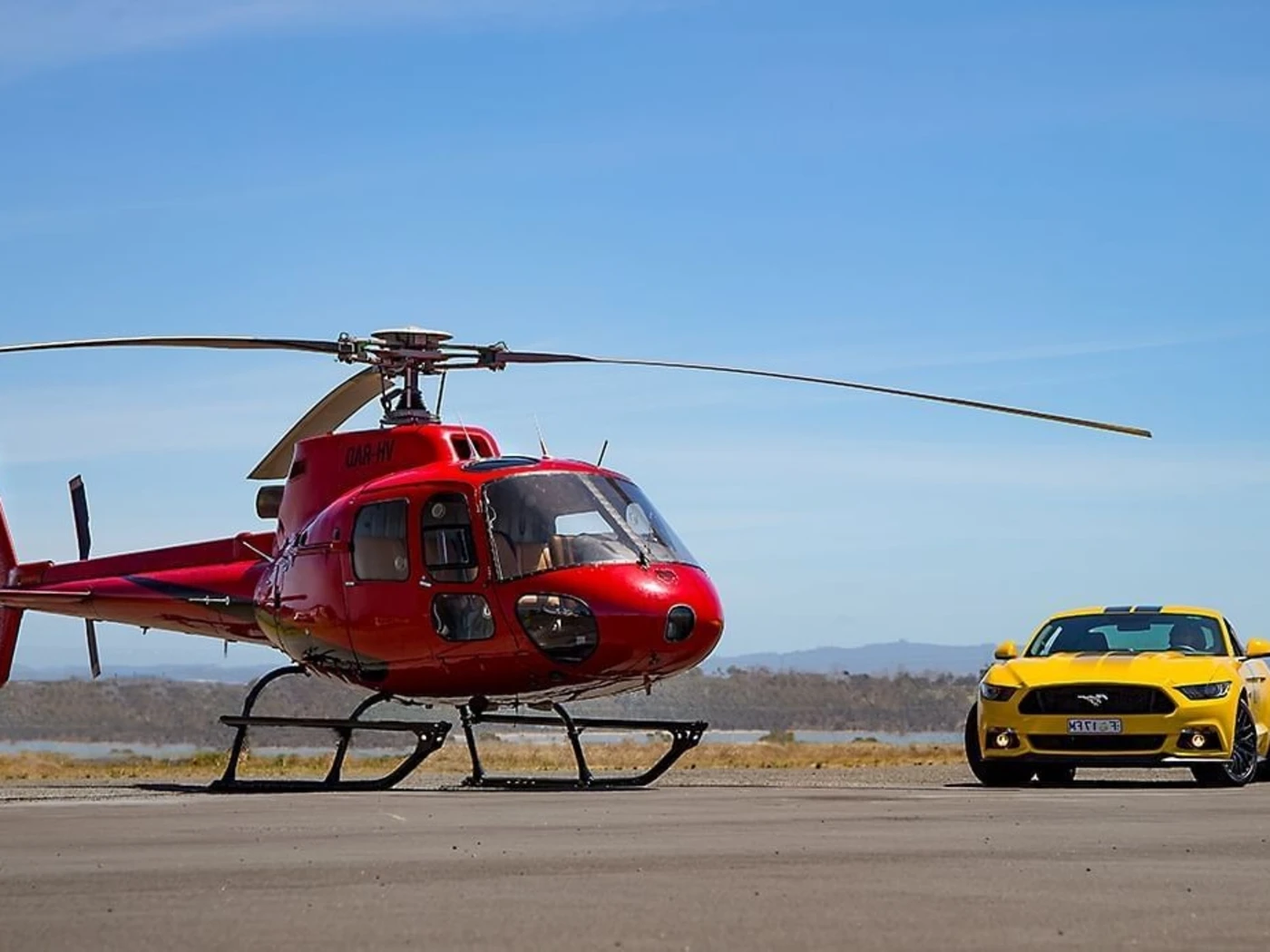 Helicopter and car parked near Freycinet Lodge