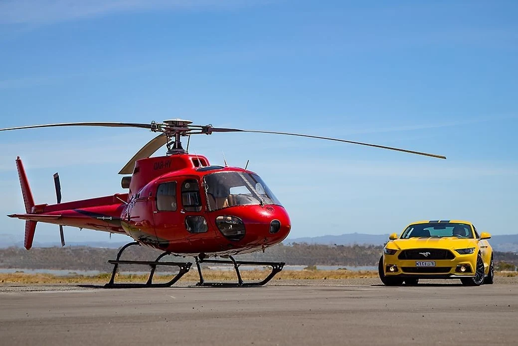 Helicopter and car parked near Freycinet Lodge